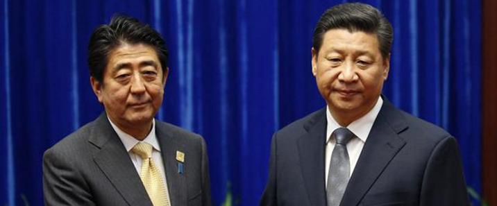 China's President Xi Jinping shakes hands with Japan's Prime Minister Shinzo Abe during their meeting on the sidelines of the APEC meetings in Beijing